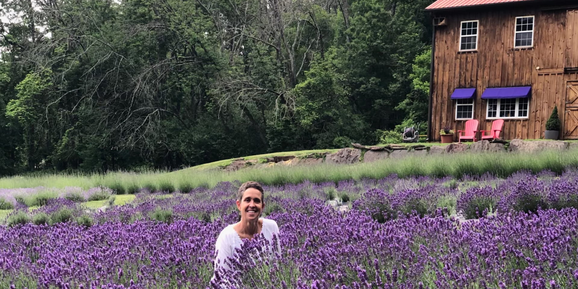 Patti Lyons in the middle of a lavender field.