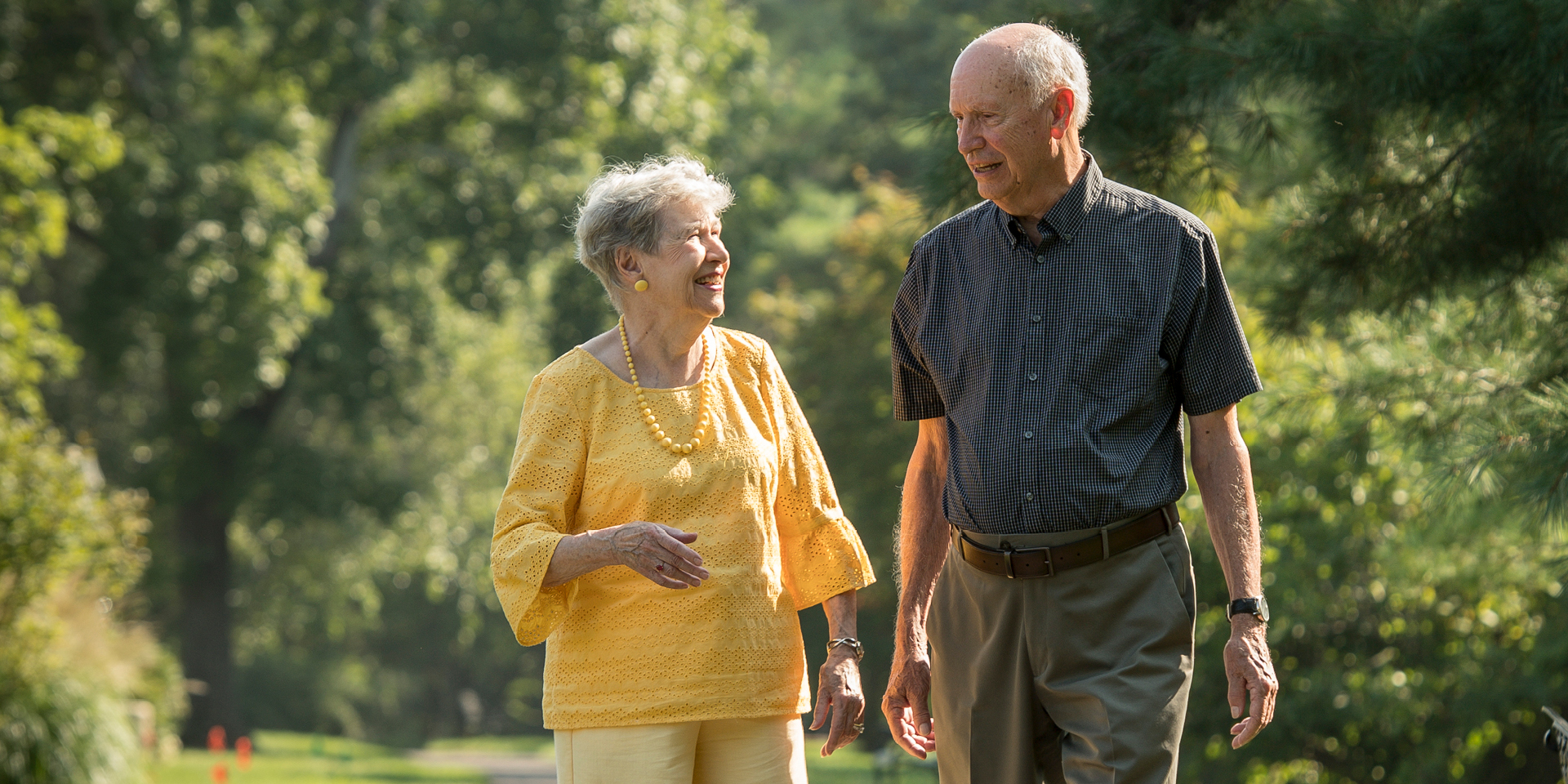 Older man and woman walking in park | Doylestown Health