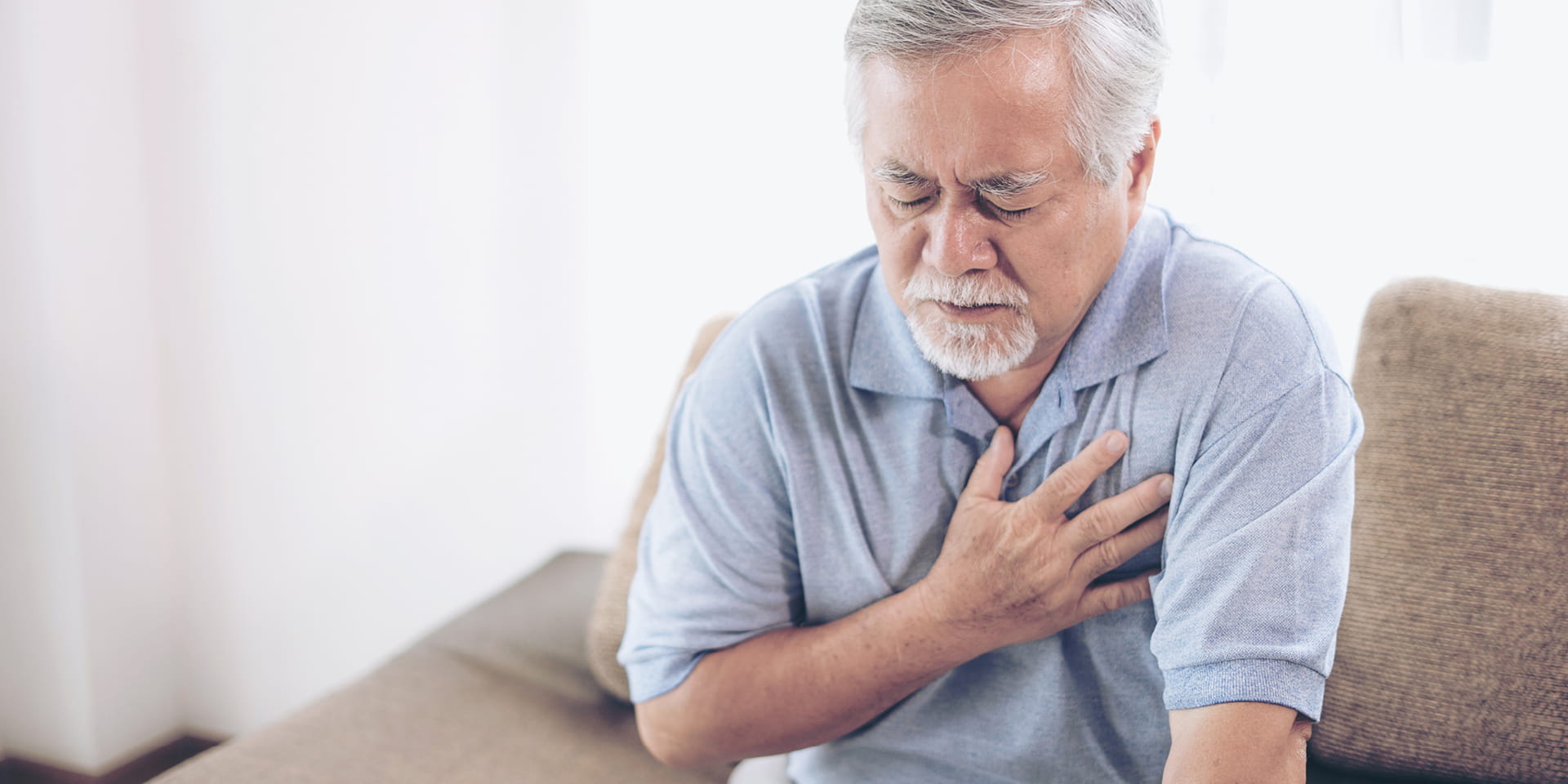 Older man clutching heart