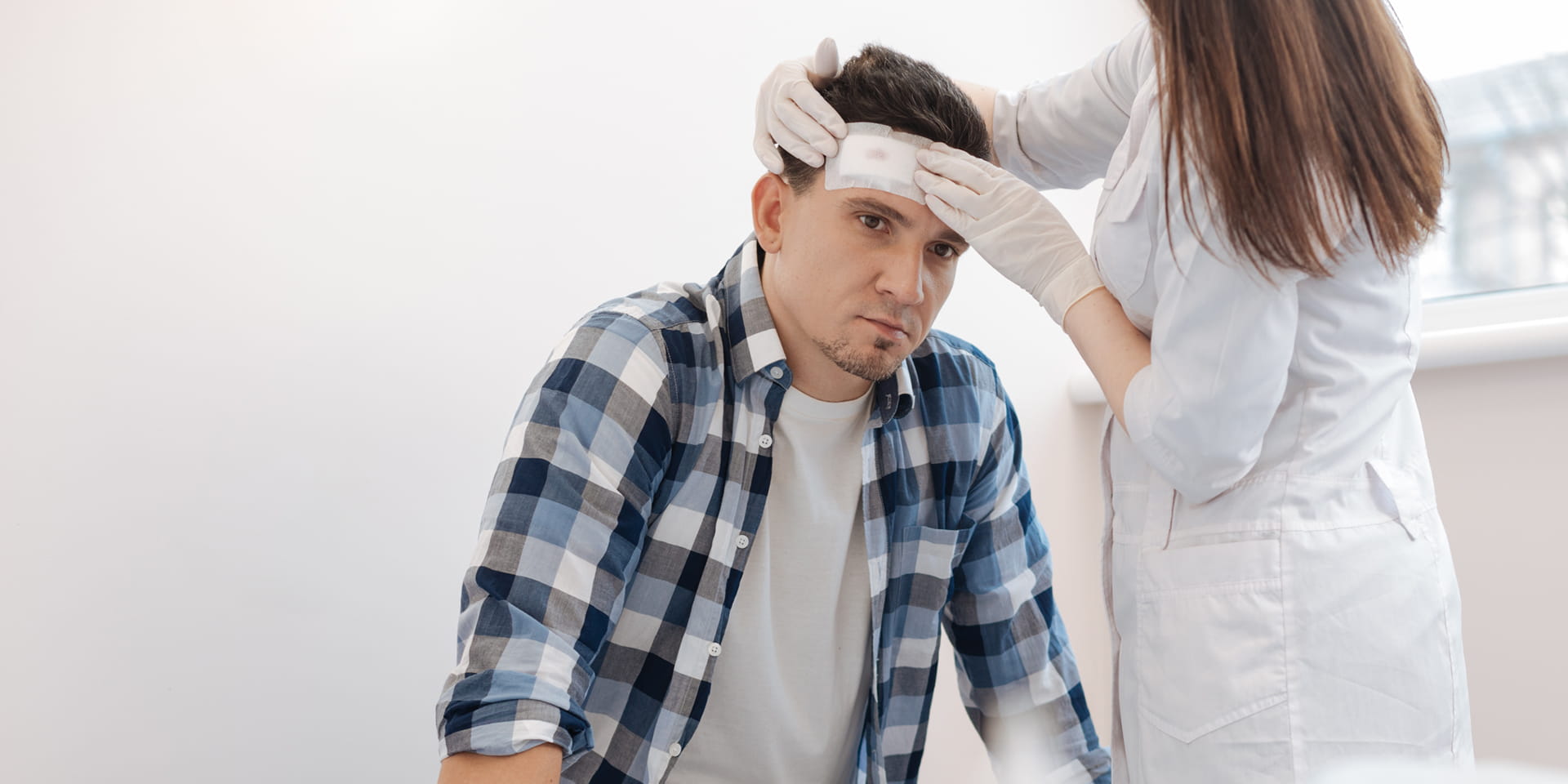 doctor wrapping young man's head