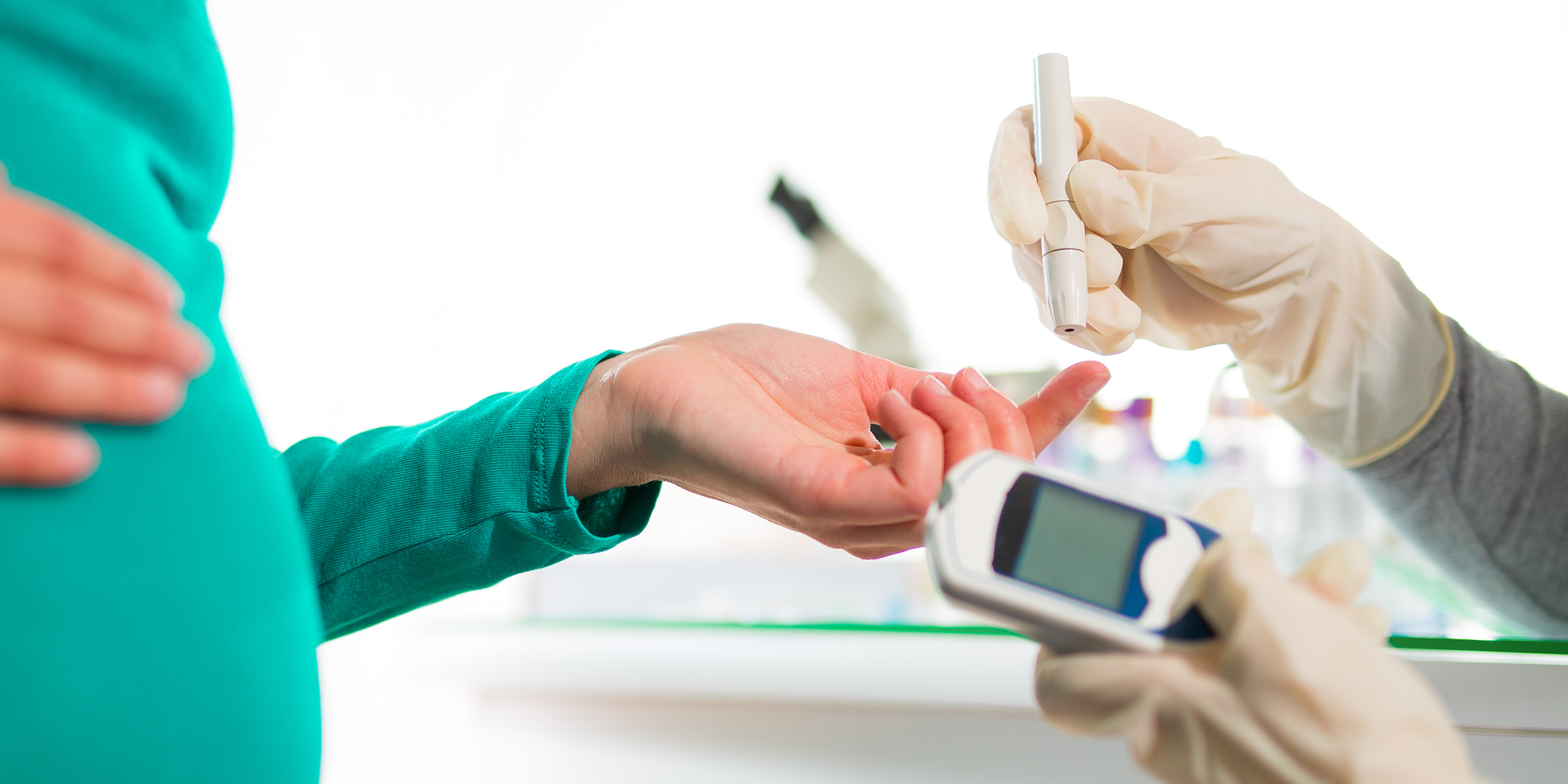 Pregnant woman getting finger prick