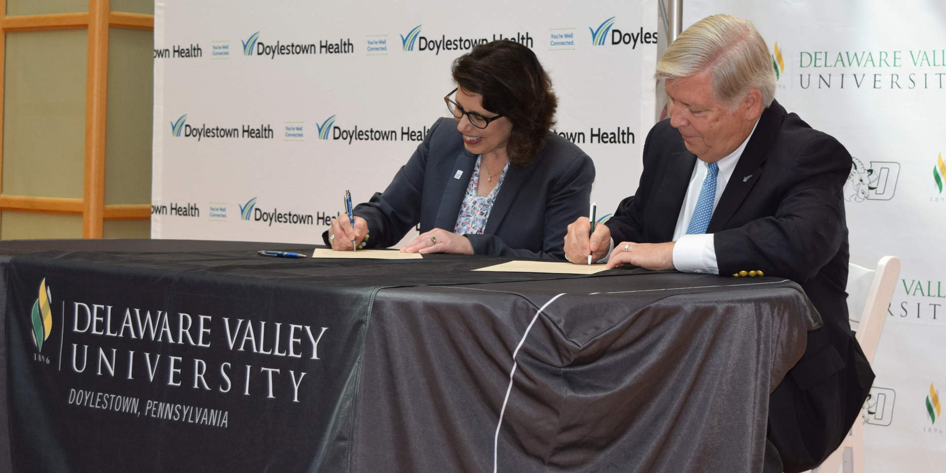 Dr. Maria Gallo and Jim Brexler at signing ceremony