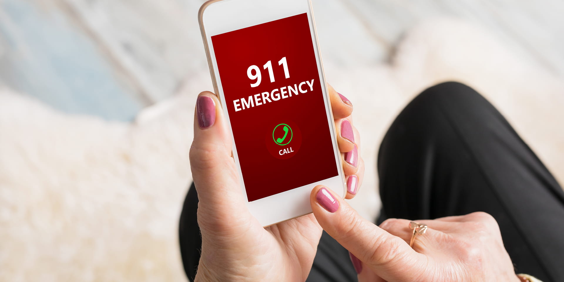 woman tapping 911 on her phone