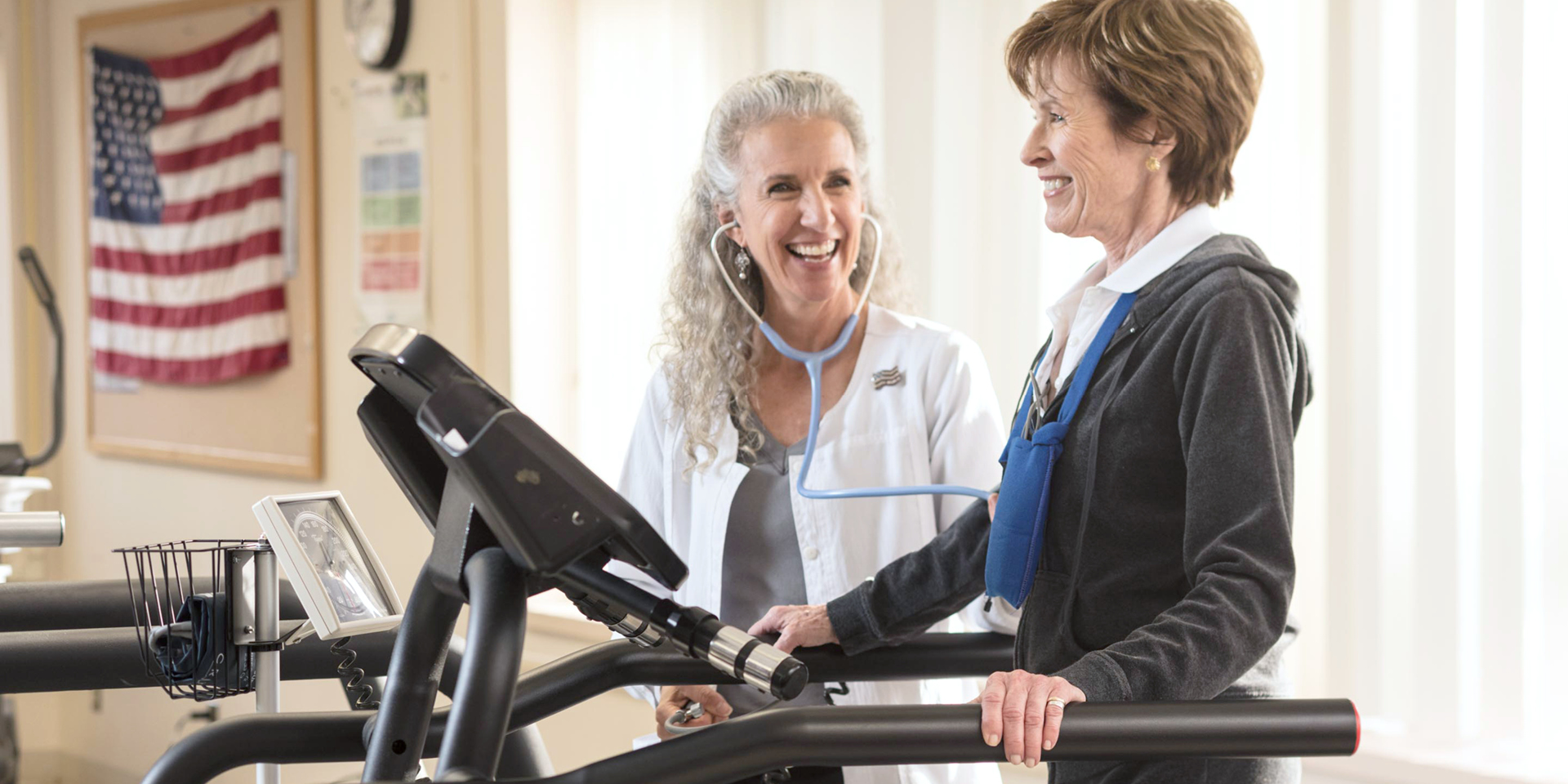 Woman on treadmill working with cardiac rehab therapist | Doylestown Health