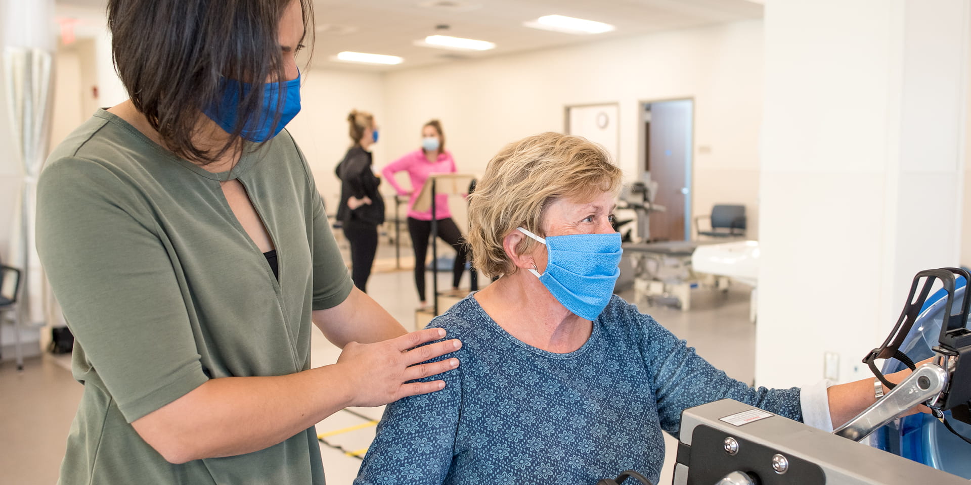 Provider helping a patient with the exercise equipment | Doylestown Health