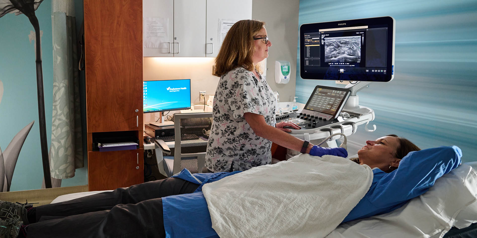 Patient with a Nurse during a Breast Exam | Doylestown Health