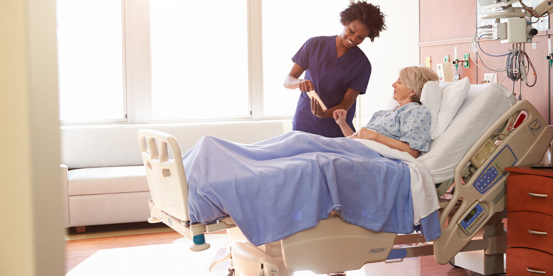 Nurse and patient in an Hospital Room | Doylestown Health