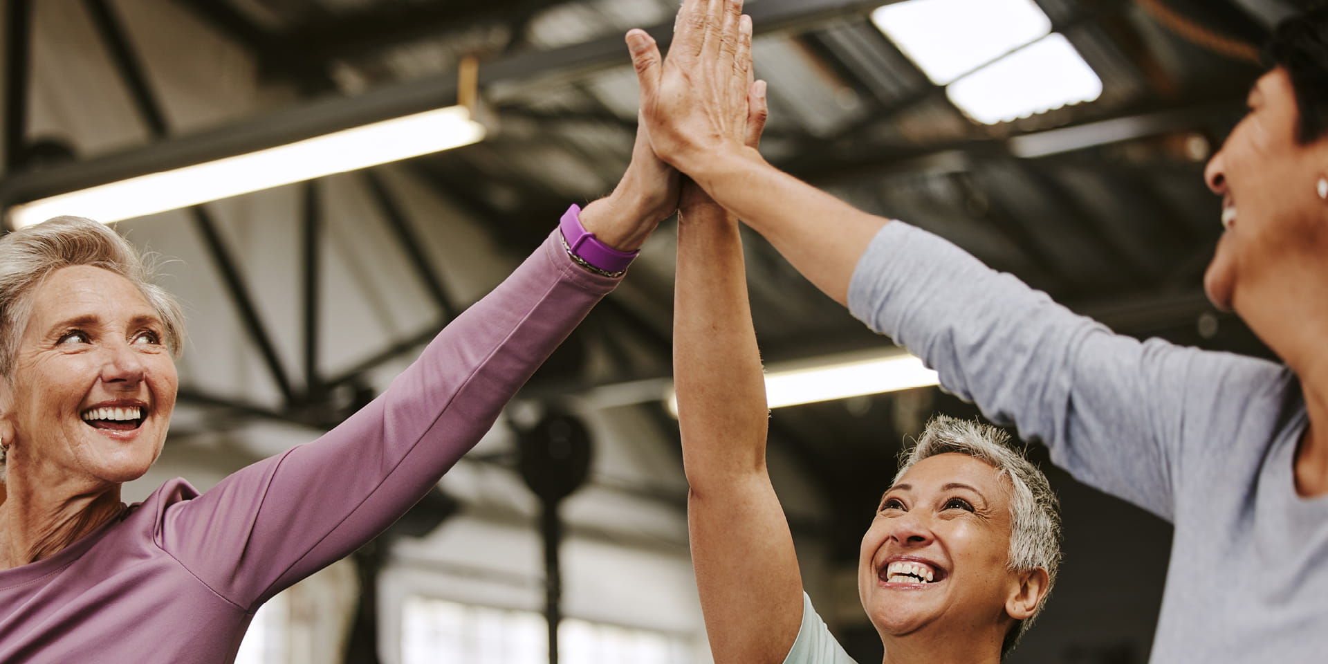 Three women doing a high five | Doylestown Health