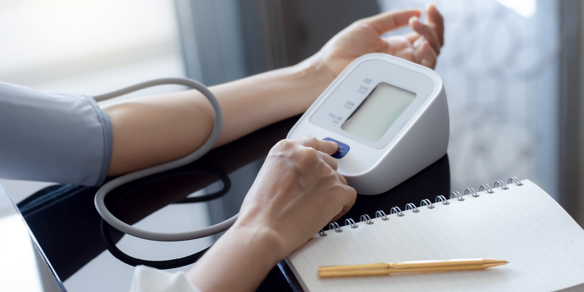 Woman checking blood pressure at home.