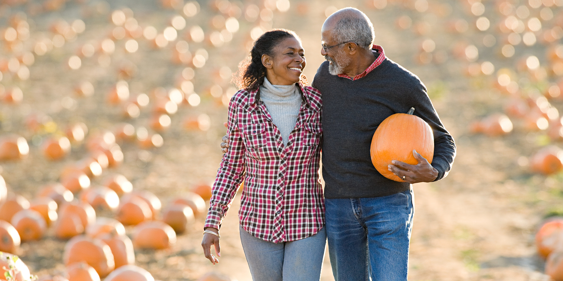 A senior couple walking through a field of pumpkins  | Doylestown Health