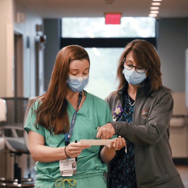 Two nurses discussing a note | Doylestown Health