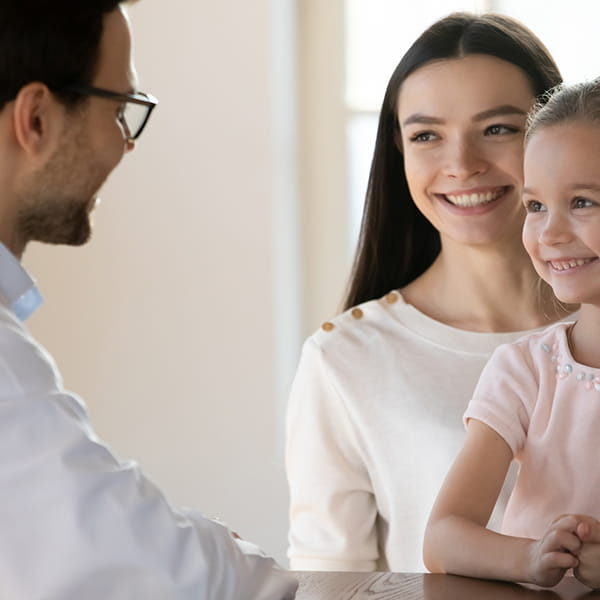 A Family Medicine resident speaking with a young patient and her mother  | Doylestown Health