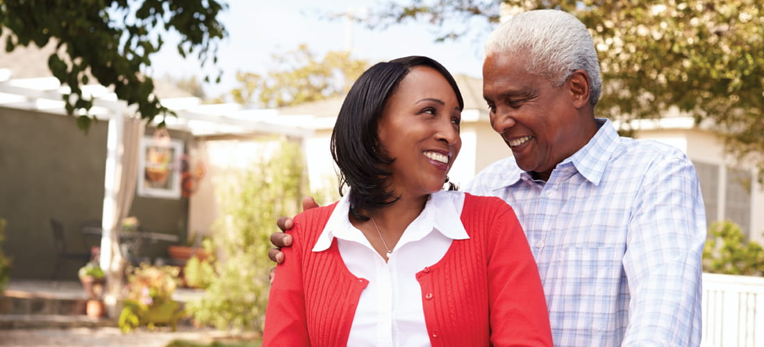 Senior black couple standing outside their new house | Doylestown Health