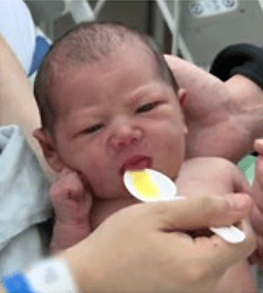 Mother spoon feeding her baby | Doylestown Health
