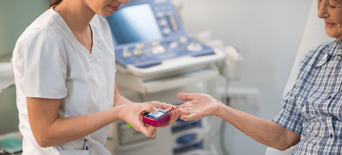 A nurse measuring a patient's blood glucose | Doylestown Health