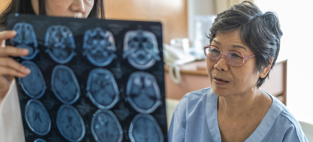 Brain disease diagnosis with medical doctor diagnosing elderly ageing patient neurodegenerative illness problem seeing Magnetic Resonance Imaging (MRI) film for neurological medical treatment, neurology provider discussing imaging results with a patient | Doylestown Health