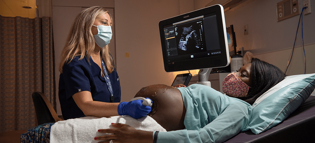 Provider operates an ultrasound  on a pegnant woman | Doylestown Health